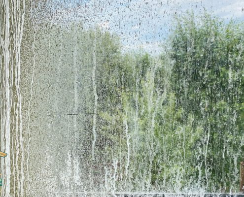 glass window pane with water stains - LoonShine Exterior Services how to remove hard water stains from home exterior windows