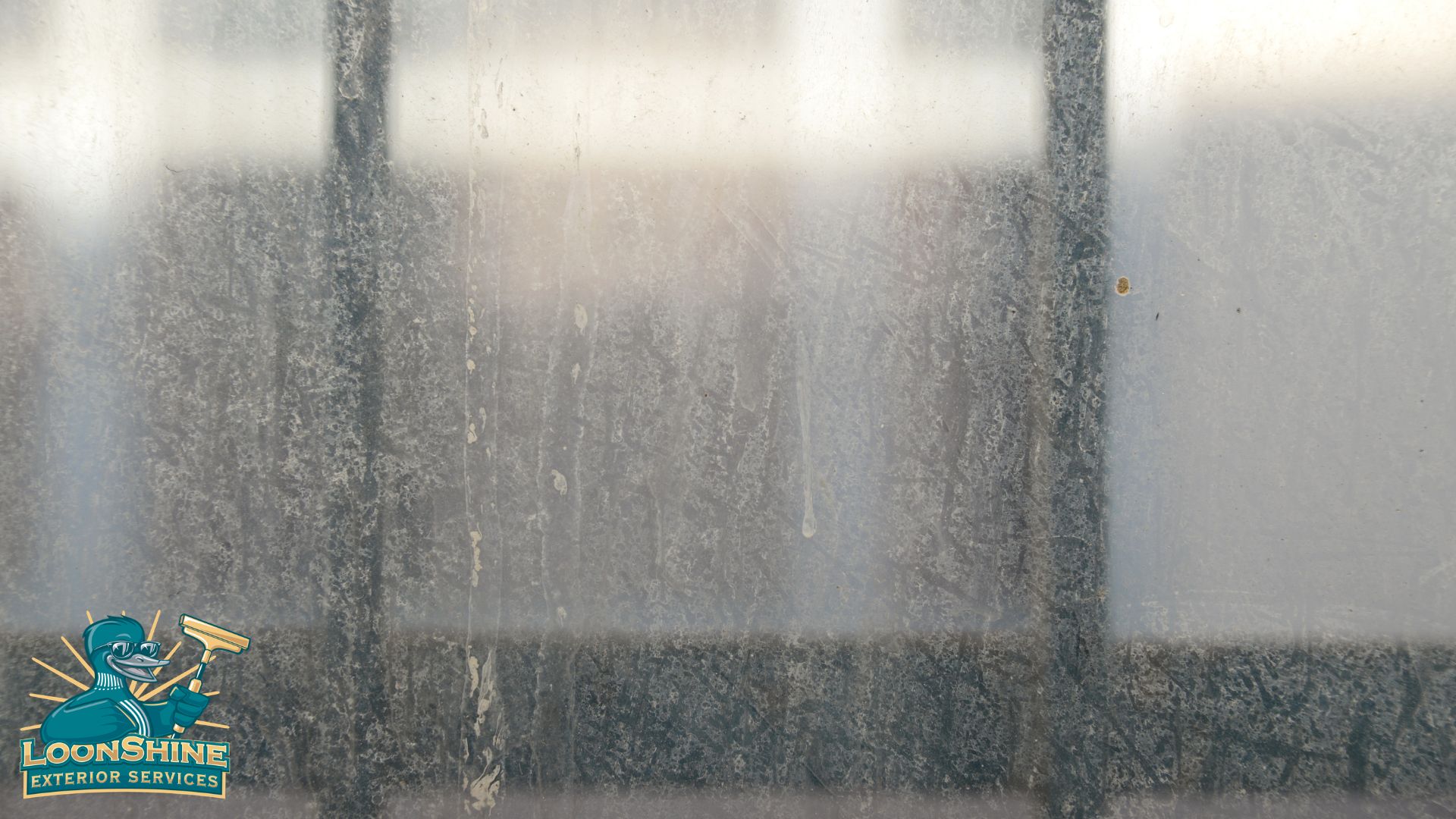 glass window pane with water stains - LoonShine Exterior Services how to remove hard water stains from home exterior windows
